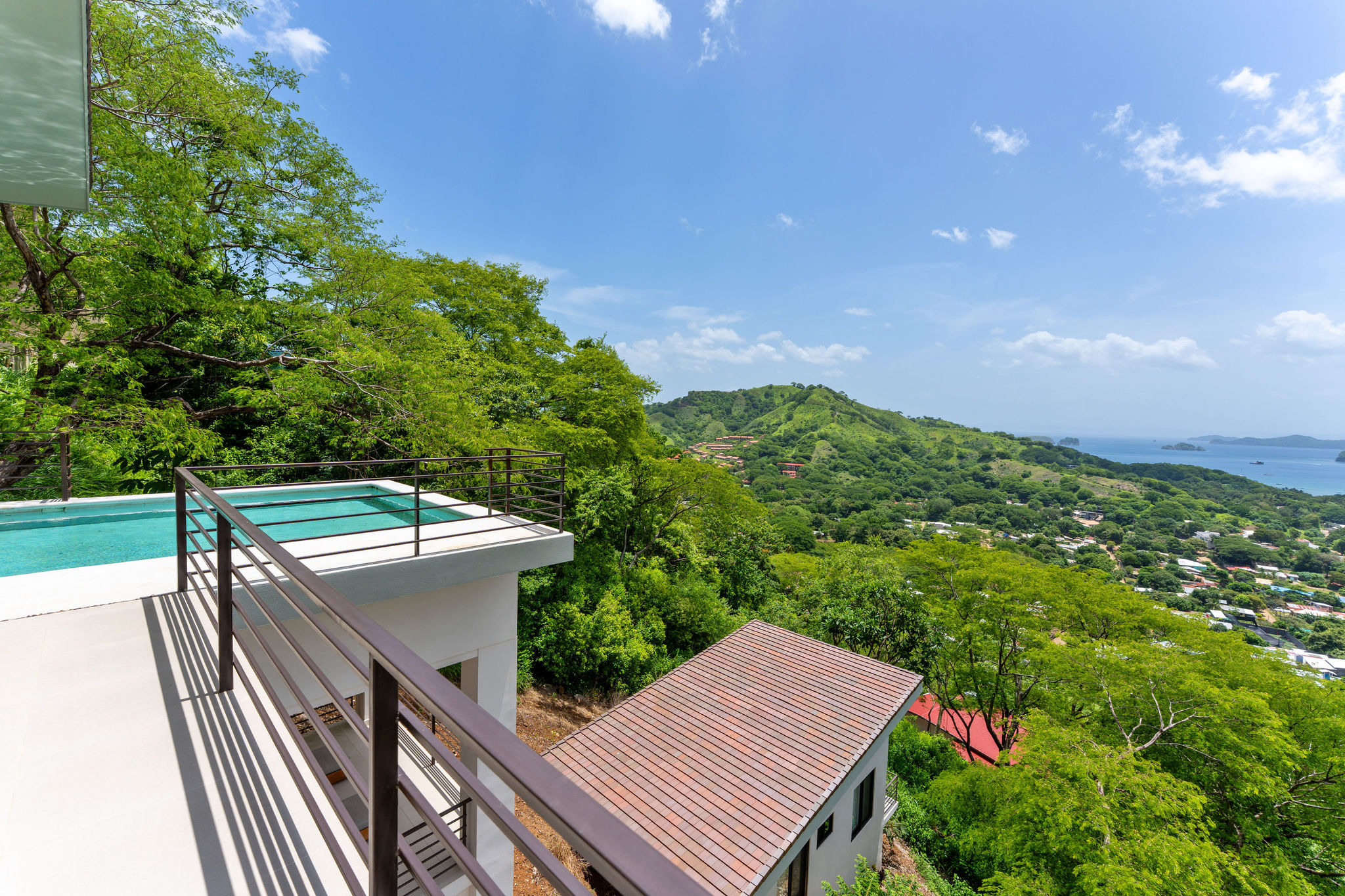 View from the terrace across tropical hills toward the Pacific