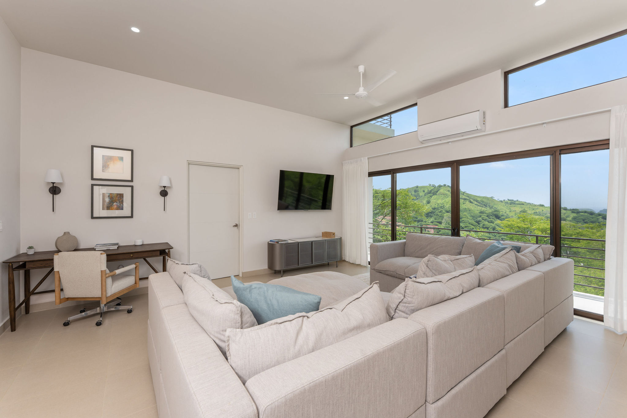 TV lounge with workspace and views of the hills