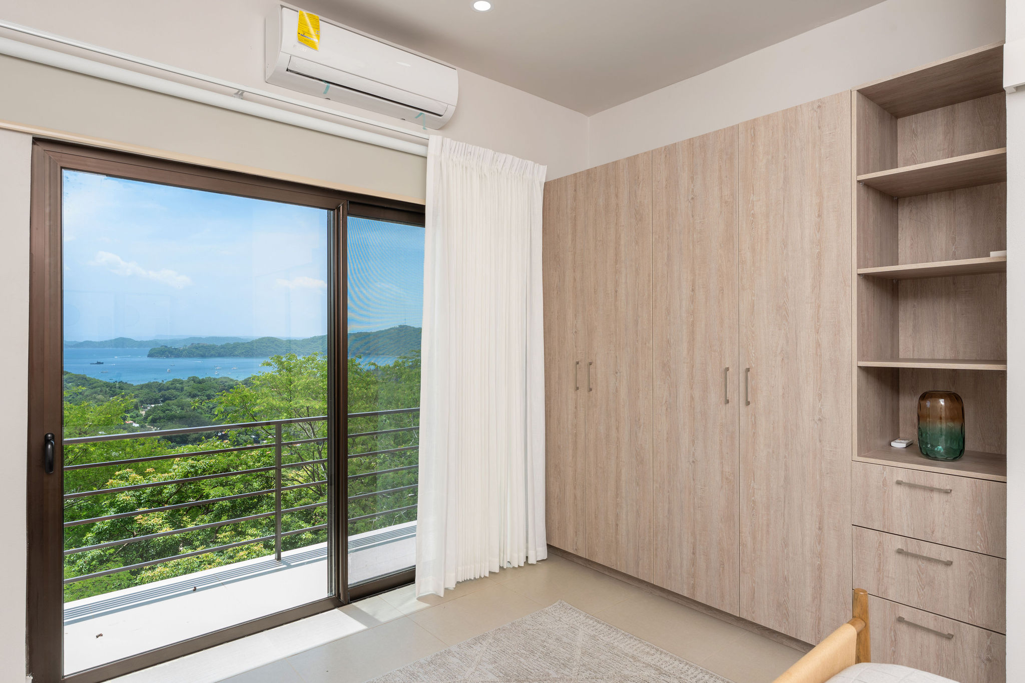 Bedroom with wardrobe storage and a balcony door