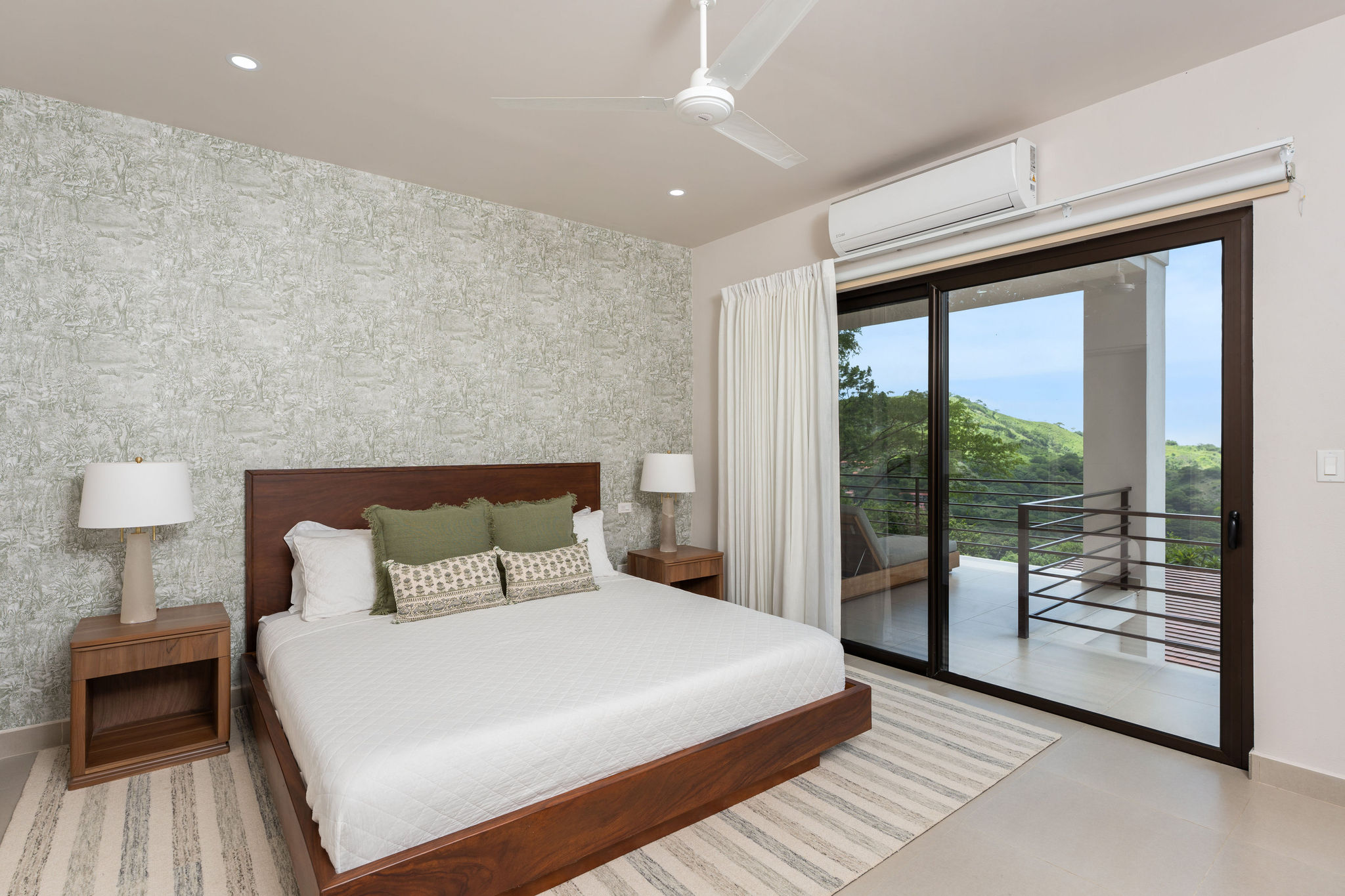 Bedroom with a king bed and sliding door to a balcony