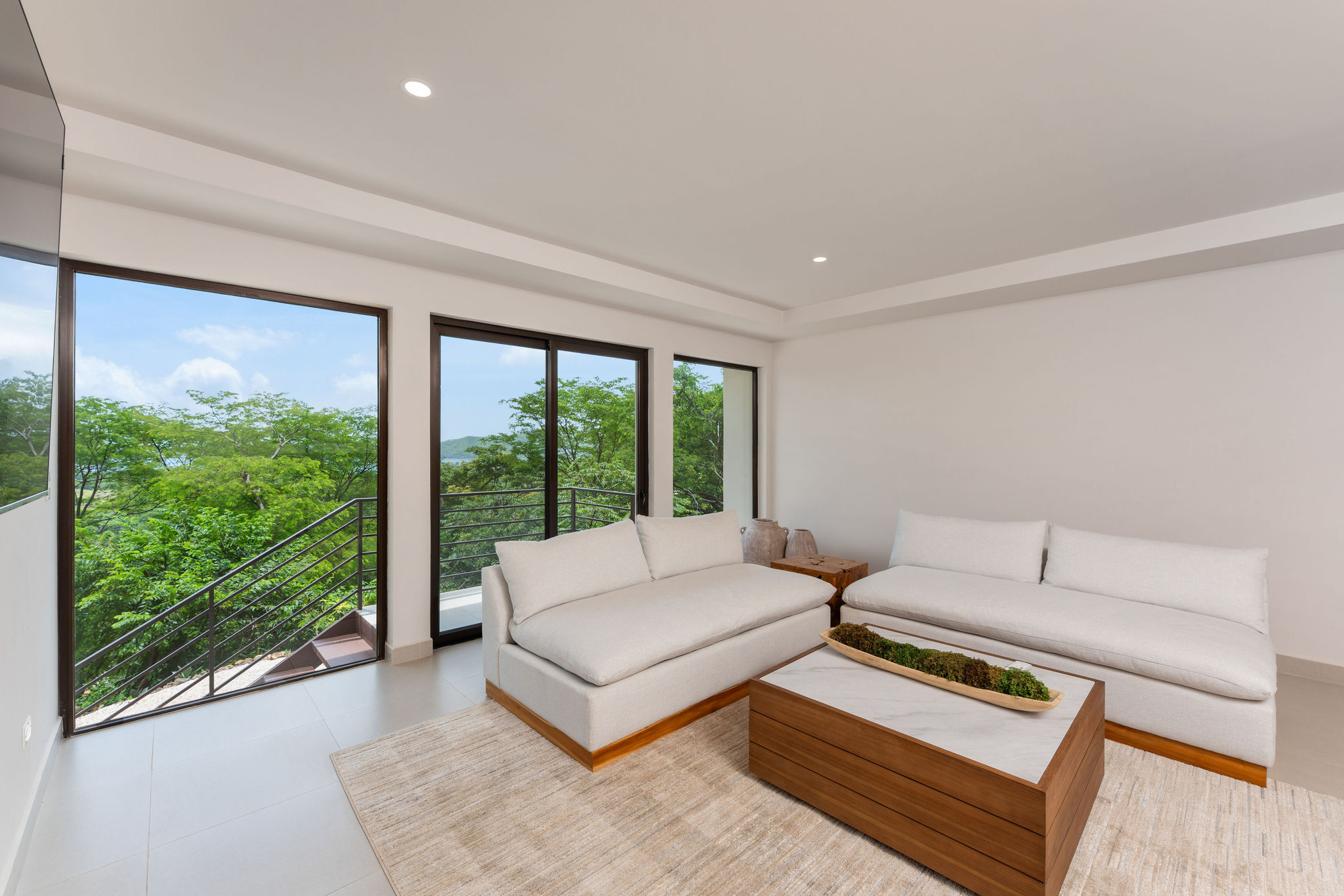 Lounge with comfortable seating and green hillside views